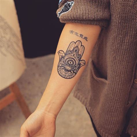 Tattoo Ideas Tattoo Hamsa Hand With Eye Meaning Infusing Spirituality With Every Stroke This Intricate Hamsa Tattoo Embodies The Celestial Harmony Of The Sun Moon And The Blossoming Purity Of A Lotus